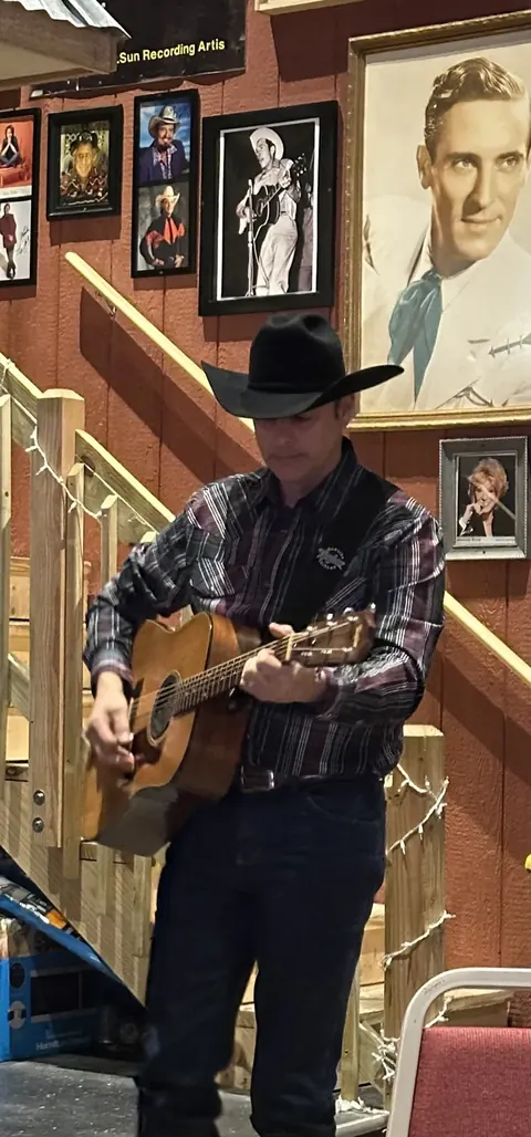 Fred Winston with his guitar at a country music venue